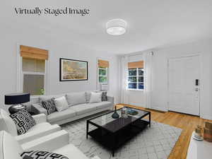 Living room featuring light wood finished floors and baseboards