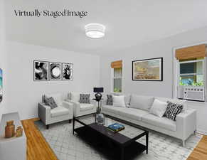 Living area featuring light wood-type flooring and cooling unit