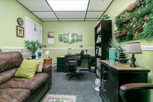 Office area featuring a paneled ceiling and carpet