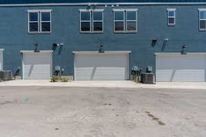 View of front of house with stucco siding and an attached garage