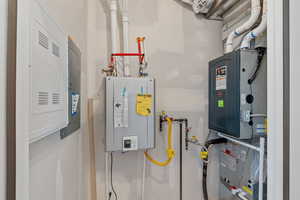 Utilities featuring tankless water heater and heating unit