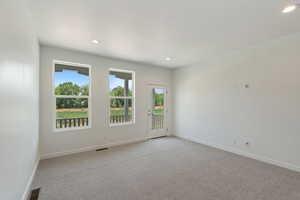 Unfurnished room with plenty of natural light, light carpet, and recessed lighting