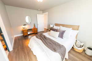 Bedroom featuring wood finished floors and baseboards
