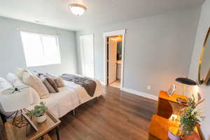 Bedroom with wood finished floors and baseboards