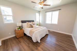 Bedroom with dark wood finished floors and ceiling fan