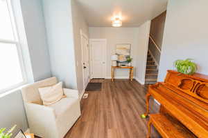 Entrance foyer with wood finished floors and stairs