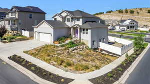 Traditional-style house featuring a residential view, a garage, and concrete driveway