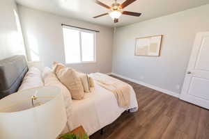 Bedroom with dark wood-type flooring and ceiling fan