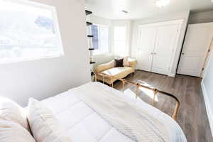Bedroom with a closet and wood finished floors
