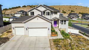 View of front of property with driveway, a mountain view, and a residential view