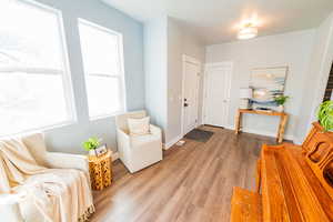 Living area with light wood-style flooring and baseboards