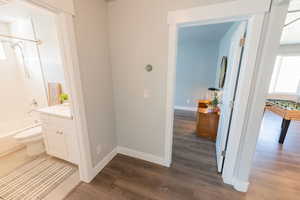 Bathroom featuring vanity, wood finished floors, and shower / bathtub combination
