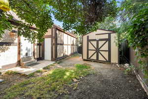 View of shed with a fenced backyard