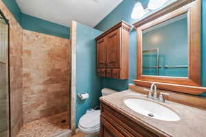 Bathroom with a shower stall and vanity