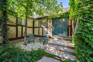 Entrance to property featuring roof with shingles