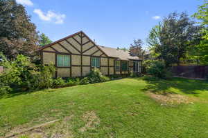 Back of property featuring stucco siding and a chimney