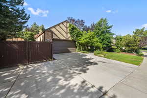 View of home's exterior with driveway, a garage, and brick siding