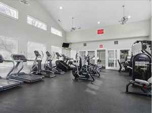 Gym featuring healthy amount of natural light, high vaulted ceiling, and recessed lighting