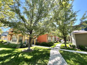 View of front of property featuring a front lawn and a residential view