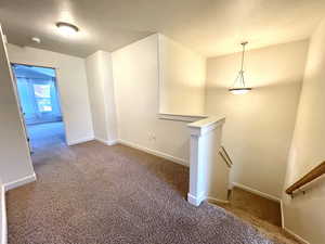 Empty room featuring carpet and a smoke detector
