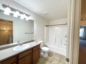 Bathroom featuring vanity, washtub / shower combination, and tile patterned flooring