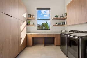 Laundry room with washer and dryer and light tile patterned floors