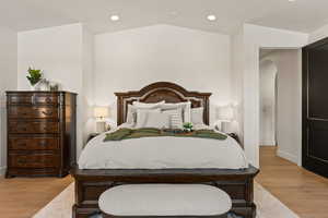 Bedroom featuring light wood-style floors, recessed lighting, and vaulted ceiling