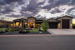 Mediterranean / spanish home featuring stone siding, a garage, stucco siding, and concrete driveway