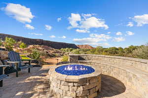 View of pool with a patio area and an outdoor fire pit