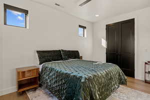 Bedroom featuring light wood-style flooring, a ceiling fan, and recessed lighting