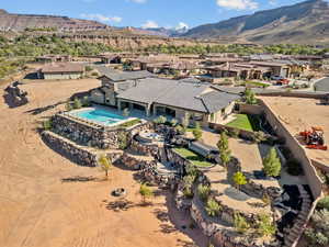 Aerial view of residential area with a pool area and a mountainous background