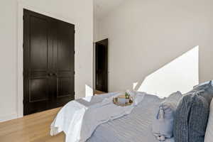 Bedroom featuring wood finished floors and a closet