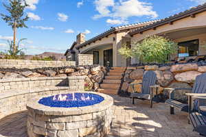 View of patio / terrace featuring an outdoor fire pit and stairs