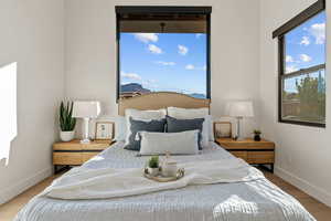 Bedroom featuring baseboards and wood finished floors