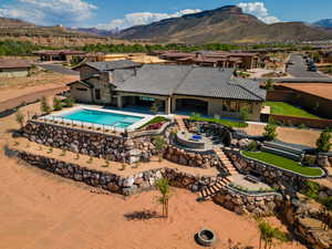 Swimming pool featuring a fenced backyard, a jacuzzi, a mountain view, a patio area, and a residential view