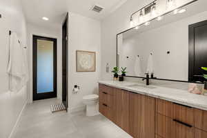 Full bath with vanity, light tile patterned flooring, recessed lighting, and a stall shower