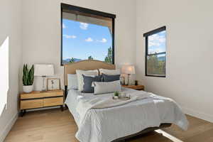 Bedroom with baseboards and wood finished floors