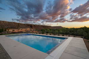 View of pool at dusk