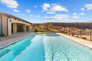 View of pool featuring a patio, a mountain view, and a pool with connected hot tub