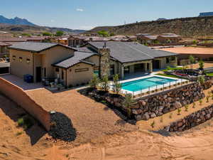 Rear view of property featuring a patio area, a tile roof, a mountain view, and stucco siding