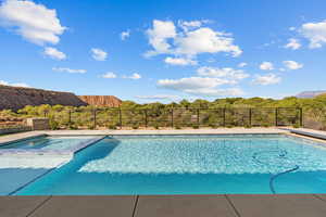 View of swimming pool featuring a pool with connected hot tub and a mountain view