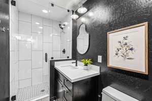 Bathroom with a shower stall and vanity