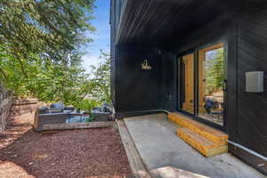 Property entrance with a patio and outdoor lounge area