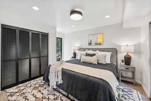 Carpeted bedroom with a closet and recessed lighting