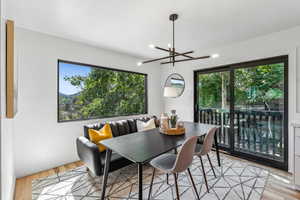 Dining room with plenty of natural light, a chandelier, and light wood finished floors