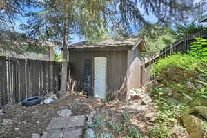 View of shed with a fenced backyard