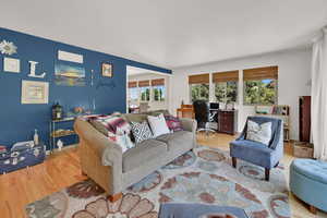 Living area with wood finished floors and an office area