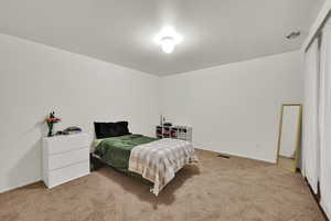 Carpeted bedroom with baseboards