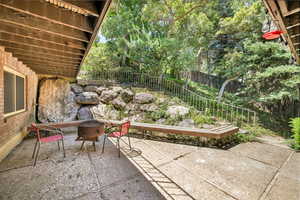 Fenced backyard featuring a patio area and a fire pit