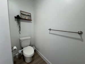Bathroom featuring wood finished floors and toilet